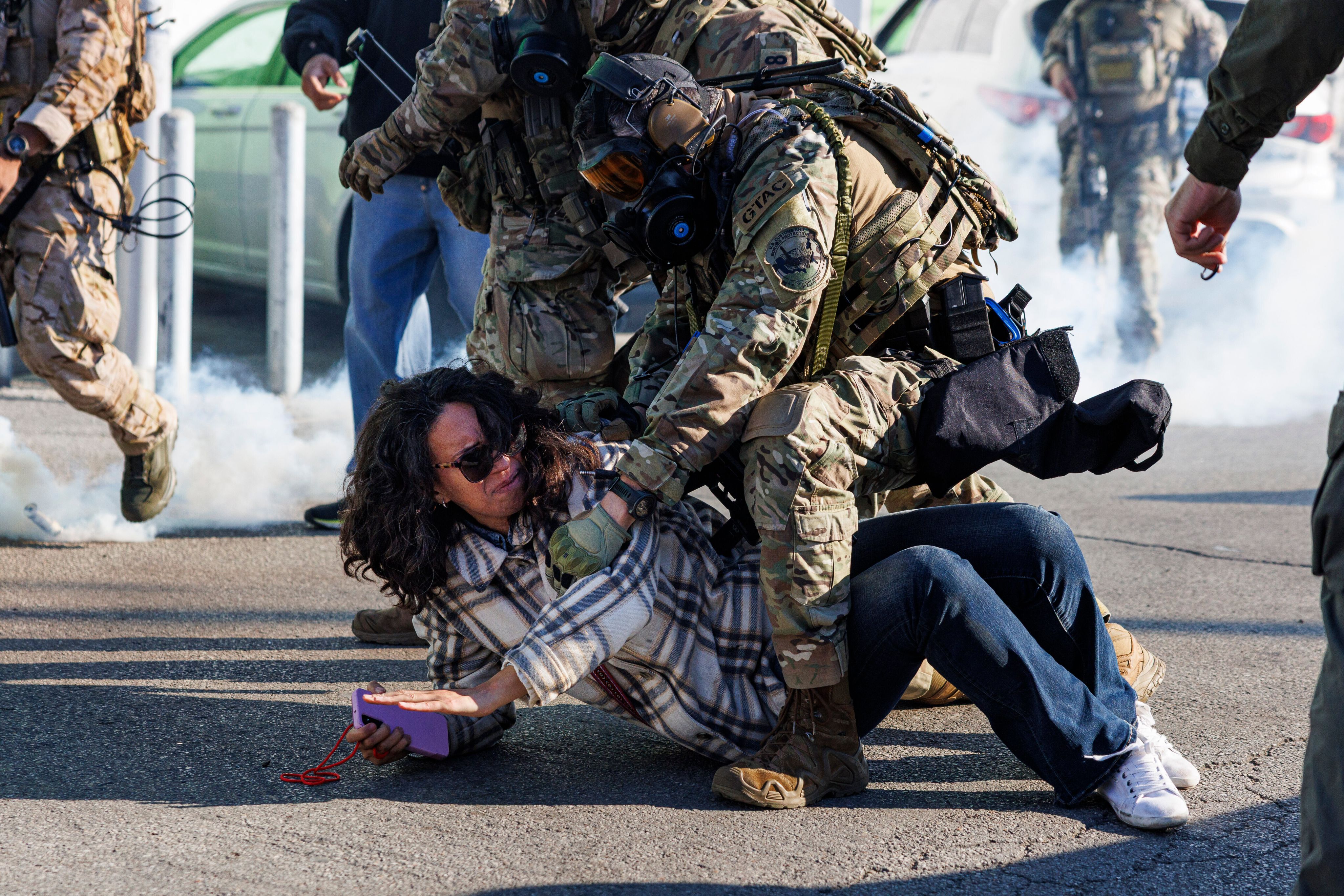 Federal immigration enforcement agents detain a protester in the Little Village neighborhood, Oct. 23, 2025. (Anthony Vazquez /Chicago Sun-Times via AP)