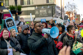 Protesters stage a rally at an AT&T store to call on the company to end its business relationship with federal agencies conducting President Donald J. Trump's mass deportation efforts. (Photo by Matthew Rodier/NurPhoto via AP)