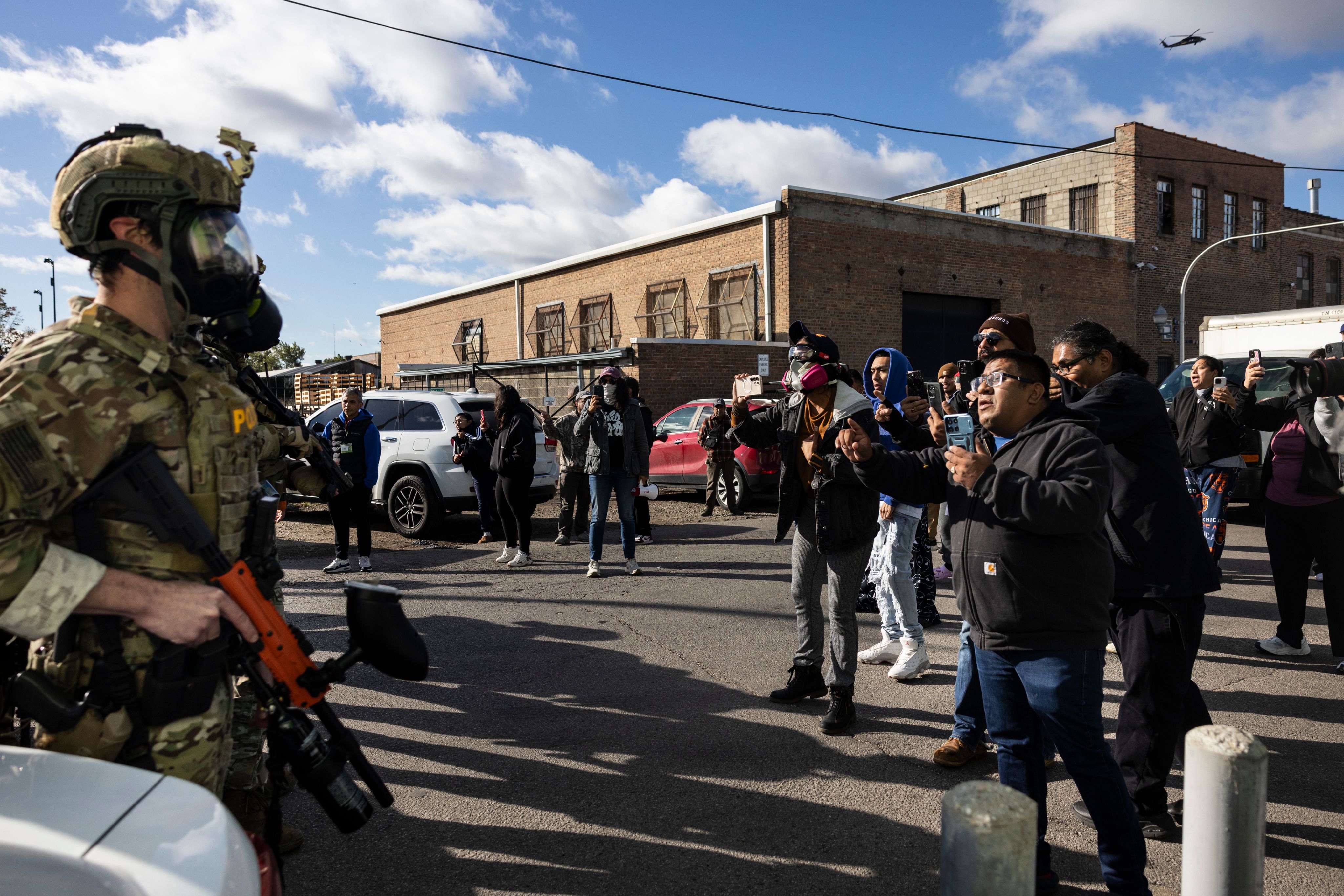 Federal immigration enforcement agents engage in a standoff with protesters in the Little Village neighborhood, Oct. 23, 2025. (Ashlee Rezin/Chicago Sun-Times via AP)